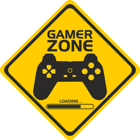 Yellow road sign with black video game controller on it. Sign says Gamer Zone with a loading bar on it.